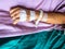 Close up hand of asian woman patient with drip receiving for injection plug in hand. IV drip with saline solution for fluid