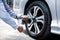 Close up hand of auto mechanic using wrench to changing a car tire.