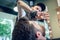 Close-up of the hand of a barber using scissors while trimming