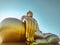 Close up hand of big Buddha statue with blue sky at Wat Tha Muang Thailand. The most specifically iconic Golden Buddha statues