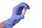 Close up of a hand in a blue latecx surgical glove holding a vial of Covid-19 Vaccine