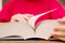 Close-up of the hand on the book is going to turn the page to the next chapter. girl leafing through the pages of the book. a girl