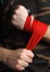 Close-up of hand boxer pulls wrist wraps before the fight