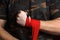 Close-up of hand boxer pulls wrist wraps before the fight