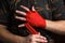 Close-up of hand boxer pulls wrist wraps before the fight