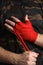 Close-up of hand boxer pulls wrist wraps before the fight