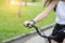 Close up hand brake bike, young woman riding bicycle in park.