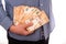 Close up hand of a businessman holding banknote into pocket. It represents very profitable investment. The exchange of