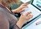 Close-up of hand of businesswoman typing on laptop