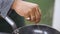 Close up of hand of Chef sprinkling spices on dish in kitchen. Clip. The chef prepares the dish. Sprinkle the salad with