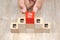 Close-up hand choose cube wooden toy block stack in pyramid with franchises business store icon for business growth and