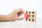 Close-up hand choose cube wooden toy block stacked with franchises business store icon for business growth and branch