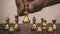 Close up hand choose gold chess to challenge with silve chess team on chess board