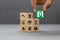 Close-up hand choose a wooden toy blocks with fire exit icon for fire safety protection