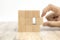Close-up hand chooseing cube wooden block toy stacked without graphics