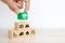 Close-up hand chooses cube wooden toy blocks stacked with prevent protect icon for safety