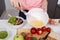 Close up of hand cooking and whisking eggs in a bowl in kitchen