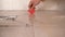 close-up of a hand of a craftsman sealing ceramic floor tiles with silicone sealant in a bathroom at home. glue sealant