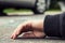 Close-up of a hand of dead person after collision with a car on