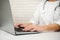 Close-up of the hand of a general practitioner, physician, doctor working on a laptop, writing text messages on the keyboard,