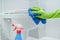 Close-up of hand in gloves with rag and detergent washing hanging toilet