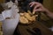 A close up of a hand grabbing a potato chip