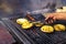 Close-up of a hand grilling arepas and chorizo, traditional Colombian food