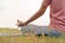 Close up hand and half body  health woman sit in lotus yoga position in the morning at park. Practicing yoga makes meditation