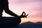 Close up hand and half body of health woman sit in lotus yoga position in the  sunset Practicing yoga makes meditation for healthy