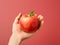 close up of a hand holding an apple