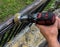 Close up of hand holding drill grinding metal fence. Construction works.  Garden/home overhaul