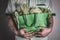 Close up a hand holding green grocery bag of mixed the organic g