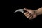 Close up of hand holding a karambit knife