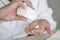 Close up hand holds white medication pills.