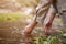 Close-up hand image of a woman touching the water in a small nature canal waterfall on the mountain