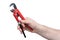 Close up of hand with iron red and black wrench isolated on white background with clipping path