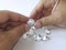 Close-up of the hand of jeweller gemologist with round cut diamonds