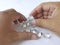 Close-up of the hand of jeweller gemologist with round cut diamonds