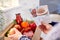 Close Up Of Hand In Kitchen Holding Recipe Cards For Online Meal Food Recipe Kit Delivered To Home