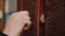 Close-up of hand knocking on door