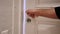 Close Up of Hand Locking the Door of House