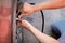 Close up hand of man inflating tire