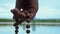 Close-up, Hand of Man with Rosary Reads Prayer on River Background