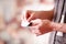 Close-up of a hand man taking out a tape of the electrostimulator electrodes in a blurred background