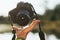 Close up of a hand of man tossing up a dslr camera