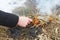 Close-up of the hand of a man who sets fire to the grass