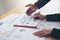 Close up hand of marketing manager employee pointing at business document during discussion at meeting room