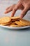 close up of hand pick sweet cookies on wooden table