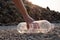 Close up Hand picking up  clear plastic bottle drop on the ground at mountain large garbage background