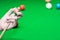 Close up hand player snooker using chalk rubbing a cue